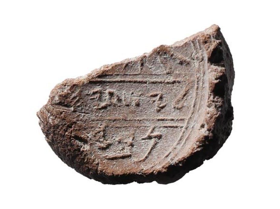 A clay seal containing the name "Isaiah".